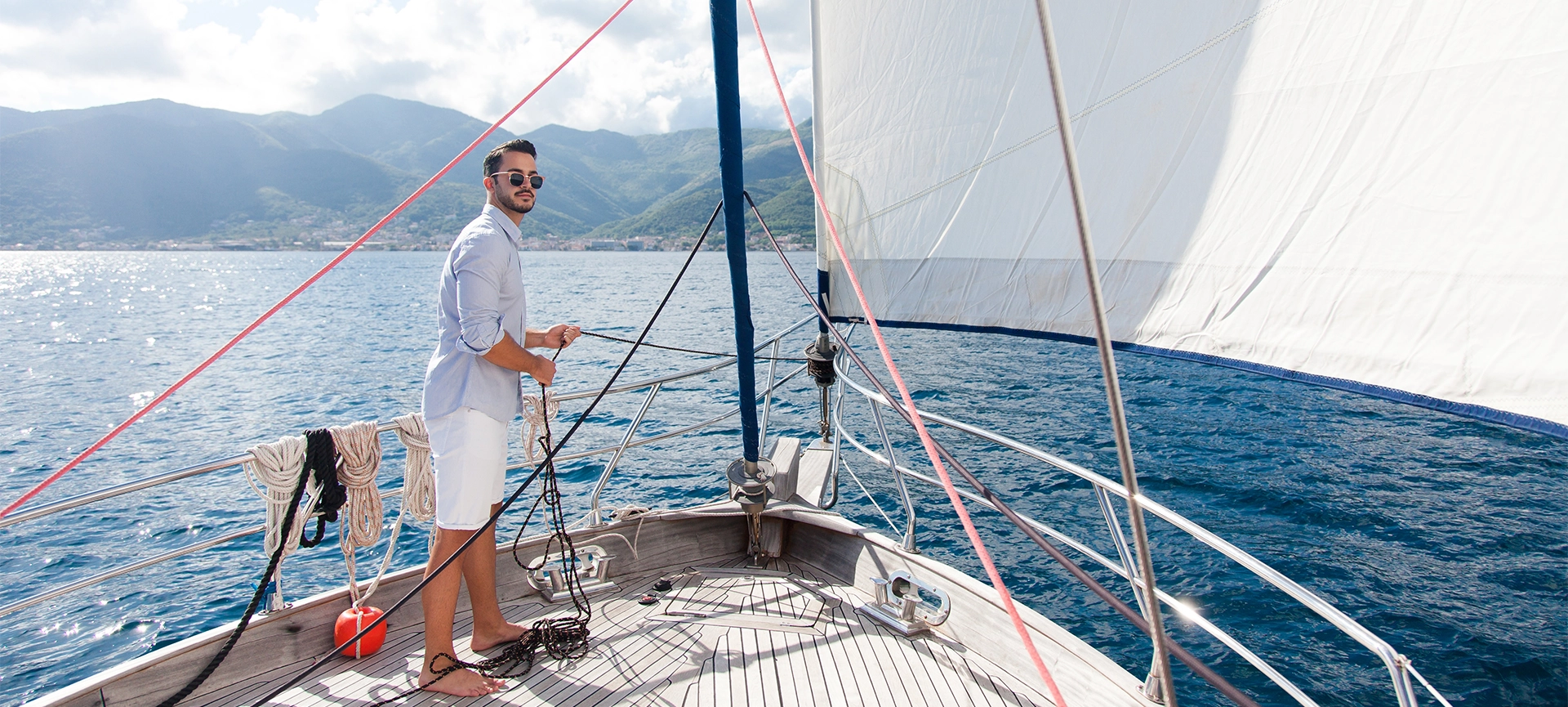 man standing in yacht