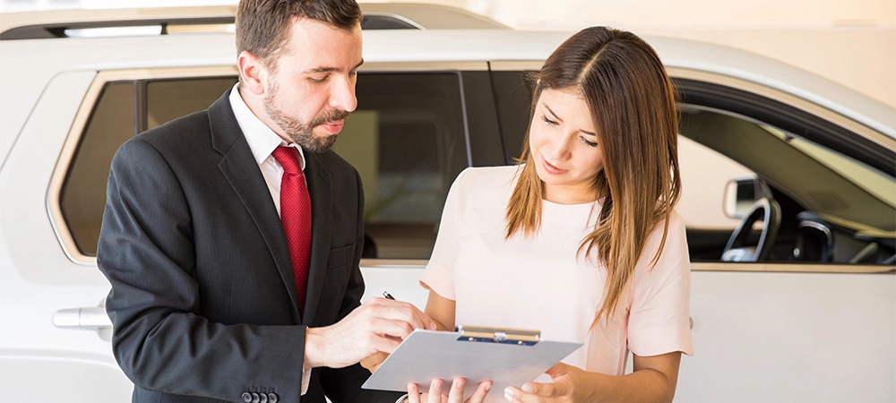 women signing on car insurance policies
