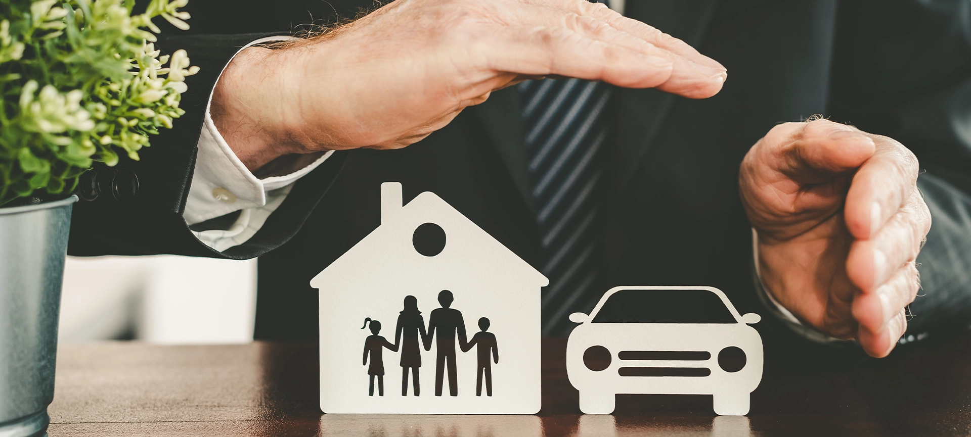 family, house and car protected by hands - concept of life, home and auto insurance