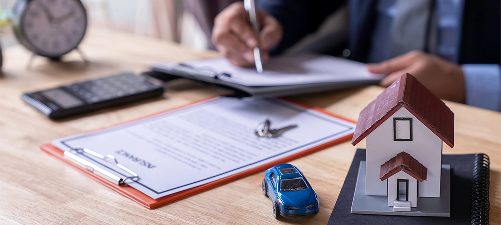 man sign a home and auto insurance policy