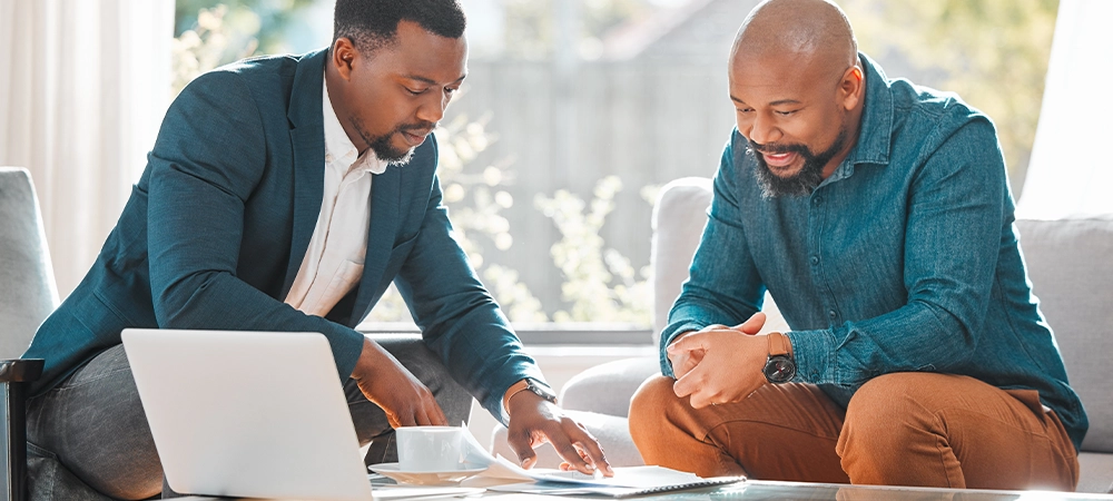 Broker, contract and talking to man in a house for meeting or consultation for advice. Financial advisor with a client or black person for investment, savings or budget and insurance plan on paper
