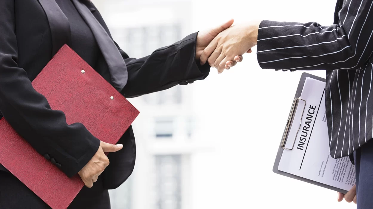 Businesswomen with insurance broker Shaking Hands In the Office