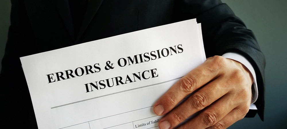 Errors and omissions E&O insurance or professional liability policy in the hands.