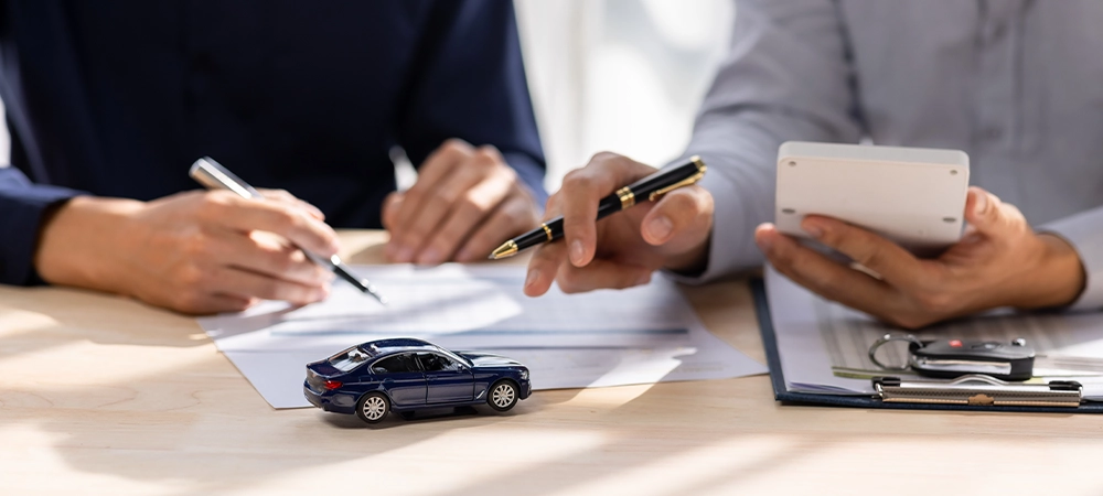 Car Insurance document or lease concept the car broker assisting his customer and explaining the detail of the car contact. Car key Buying or selling signing .
