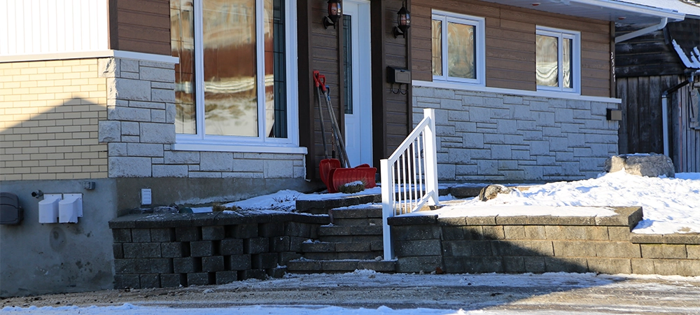 Snowy house in the village on a sunny winter day, Canada