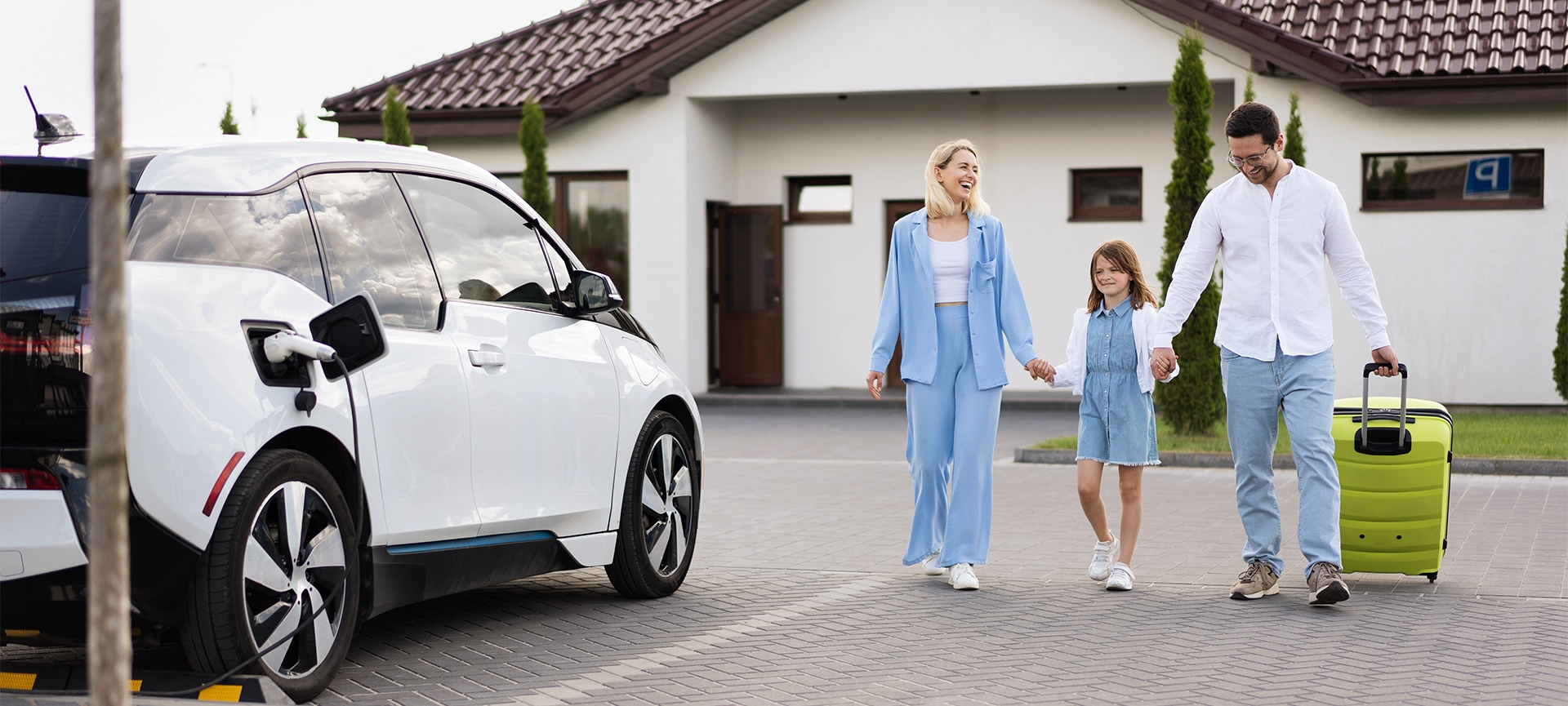 Happy Family Leaving Home With Electric Car Concept