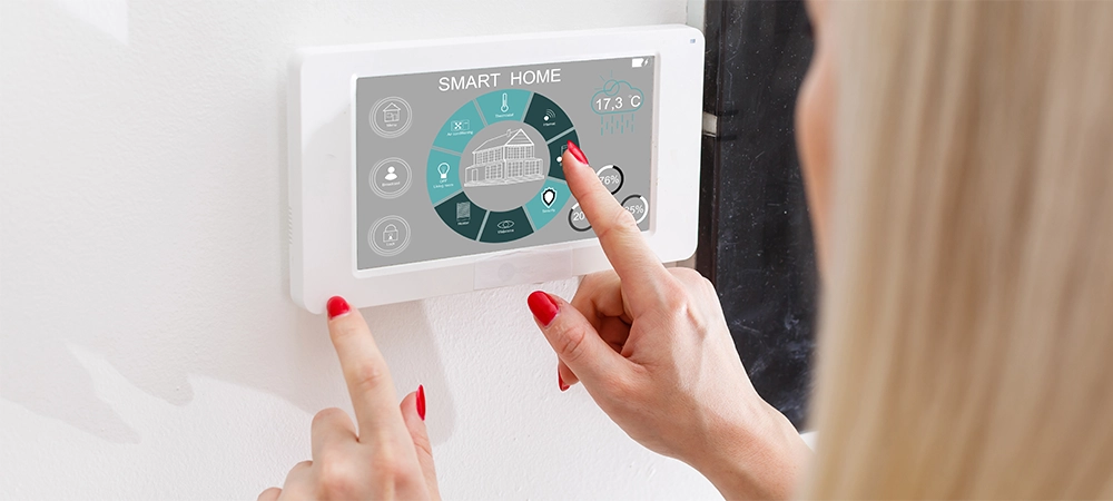 Woman use application for smart home control on tablet. Interior of living room in the background.